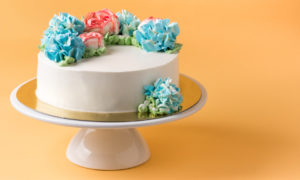 Cake on cake stand with yellow background