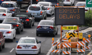 traffic jam with expect delays sign