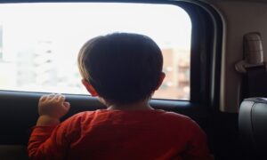 Kid looking out of car window