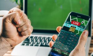 excited person holding phone while watching live sports betting