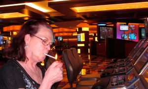 Photo of a woman smoking inside of a casino for a story about the House Health Committee passing a bill today that would eliminate indoor smoking at Pennsylvania casinos.
