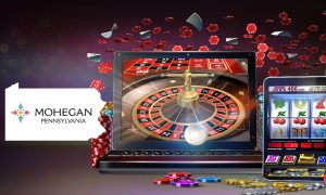 Image showing online casino gaming with slots and roulette on mobile devices along with the PA state outline featuring the Mohegan Pennsylvania logo for a story about the retail casino announcing its plans to launch its own branded online casino app.