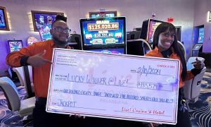 Photo showing two Live! Casino Philadelphia employees holding up the winner's check for a story about the Keystone State casino setting a new slot jackpot record this weekend of over $180K.