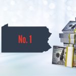 Image showing online casino gaming with slot reels on devices along with the PA state outline featuring the words "No. 1" for a story about the Keystone State solidifying itself as the top online casino market in the US this year.
