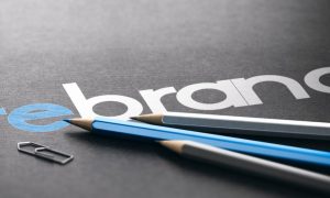 The word "rebrand" on a black background with three pencils. Mohegan Pennsylvania is using its own name for its retail sportsbook, which aligns with the property's new omnichannel strategy.