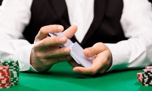 Poker dealer shuffling cards. The new poker room opening at the Hollywood Casino at Penn National Race Course tops the July PA poker highlights.