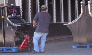 Worker removing slot machines from a casino. Hollywood Casino at Penn National Race Course conducted its own research on skill games and received approval to remove 169 slots.