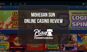 Mohegan Sun Online Casino Review: Online casino homepage featuring slot game promotions, free spins offer, and Play Pennsylvania review logo